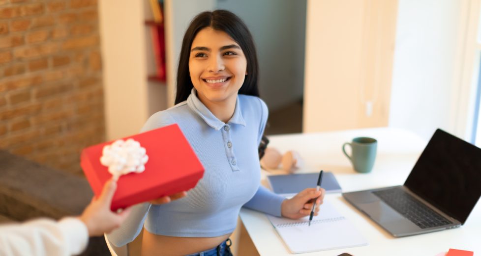 Employee receiving personalized gift with emotional reaction
